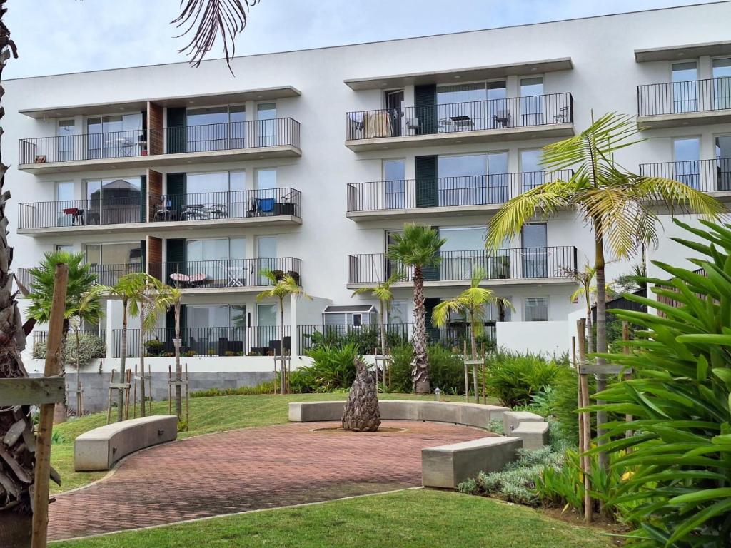 an apartment building with a garden in front of it at Coliseum Residence in Ponta Delgada