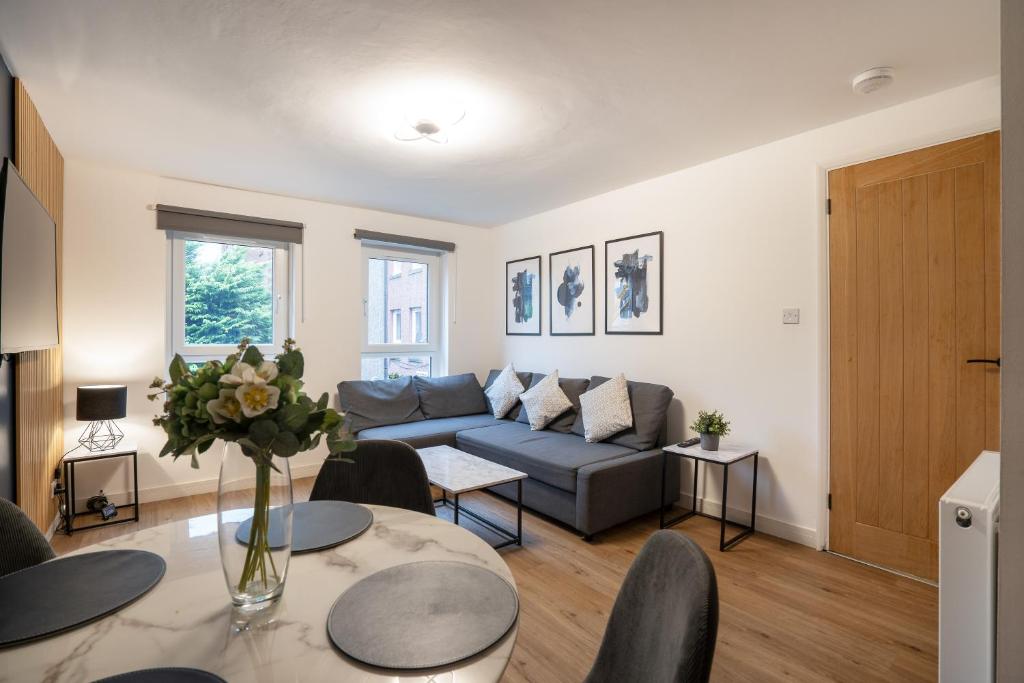 a living room with a couch and a table at Modern 2BED Apartment-Free Parking in Edinburgh