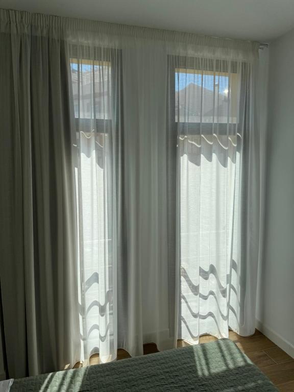 Posteľ alebo postele v izbe v ubytovaní Plaza Victoria Apartments