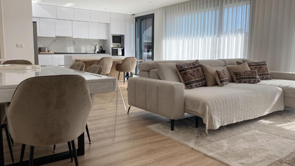 a living room with a bed and a table and chairs at Castelo View in Pombal