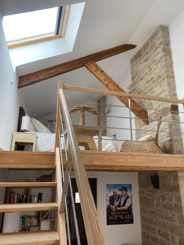 a staircase in a room with a book shelf at Bienvenue au Gite La So Sweet in Rully