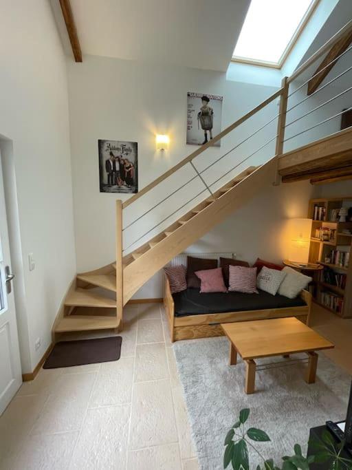 a living room with a staircase and a couch at Bienvenue au Gite La So Sweet in Rully