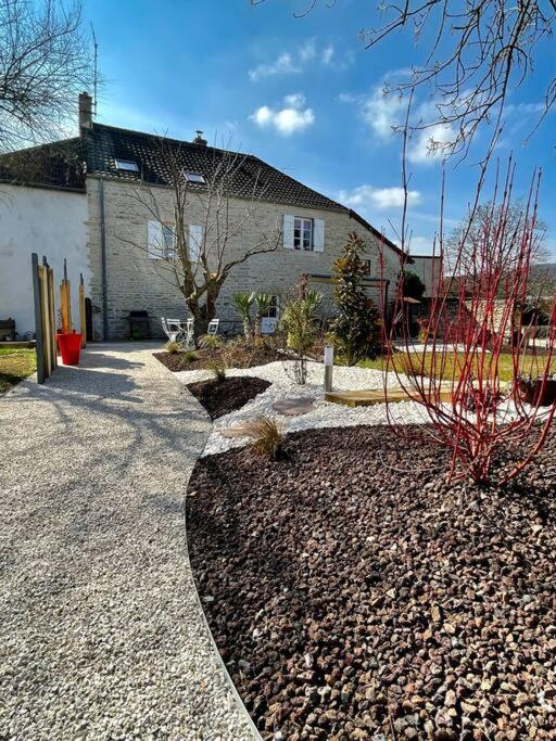 a house with a building and a gravel driveway at Bienvenue au Gite La So Sweet in Rully