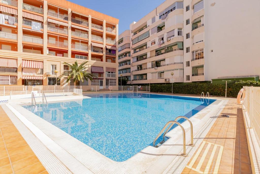 a large swimming pool in the middle of a building at Cozy stay in Pobla Farnals - 15 min from Valencia in Puebla de Farnals