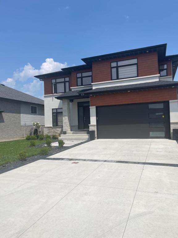 a house with a large driveway in front of it at Luxury Modern smart home for vacation in Windsor