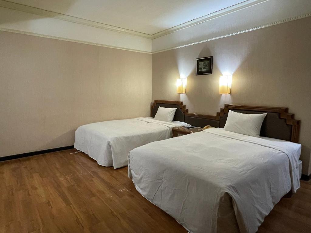 Postel nebo postele na pokoji v ubytování Tapeng Bay Holiday Hotel