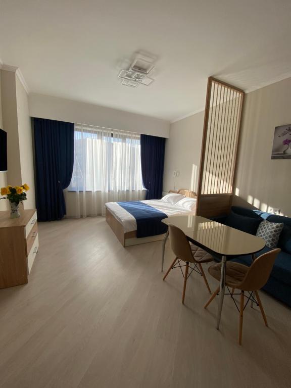 a hotel room with a bed and a table at Sunny Paradise in Tsaghkadzor in Tsaghkadzor