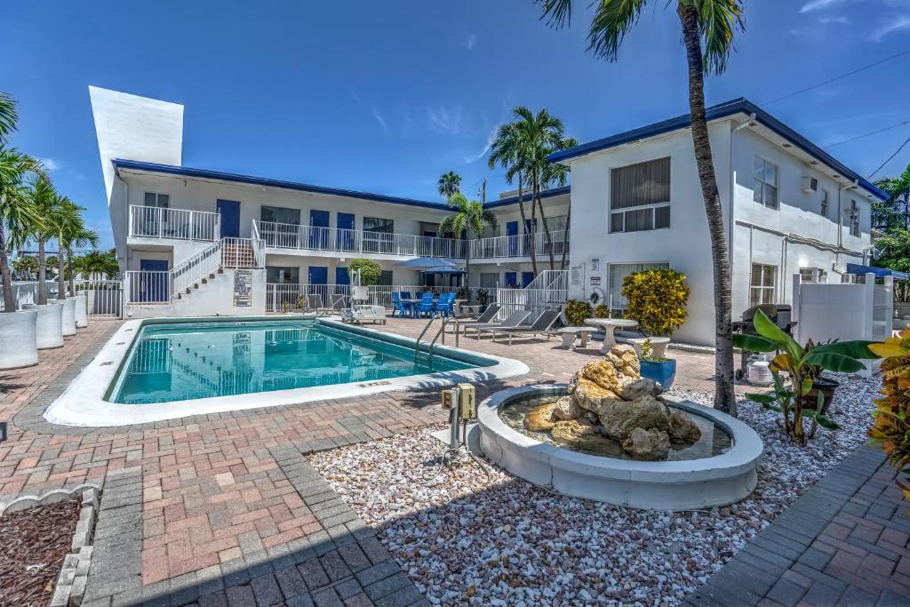 an image of a house with a swimming pool and a building at Blue Strawberry by the Sea in Fort Lauderdale