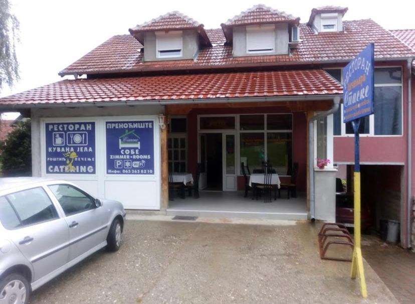 a car parked in front of a building with a restaurant at Sobe Spaske in Čačak