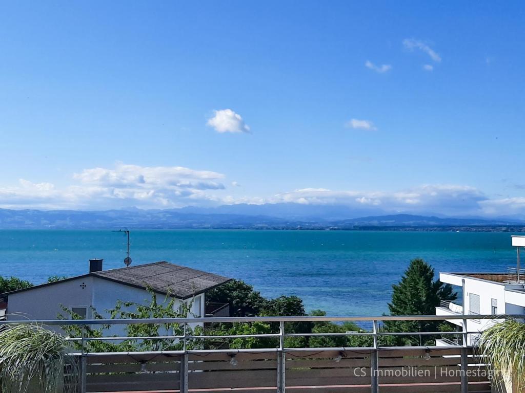 a view of the ocean from a balcony at Designerloft See in Immenstaad am Bodensee