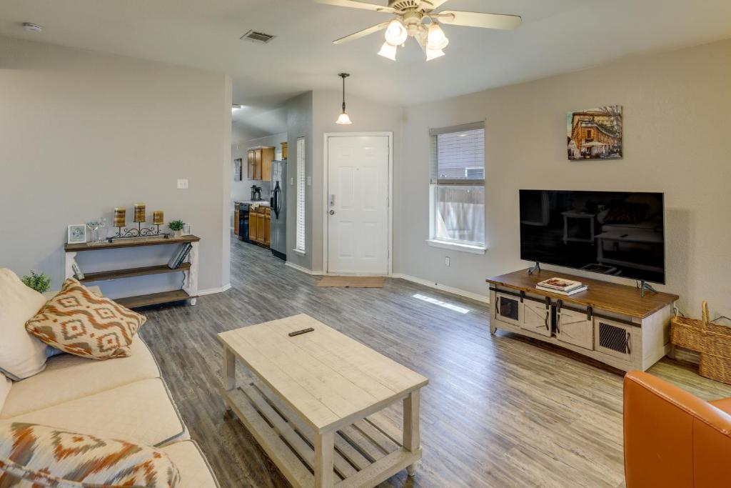 a living room with a couch and a flat screen tv at Ideally Located Austin Home with Fenced-In Yard! in Austin