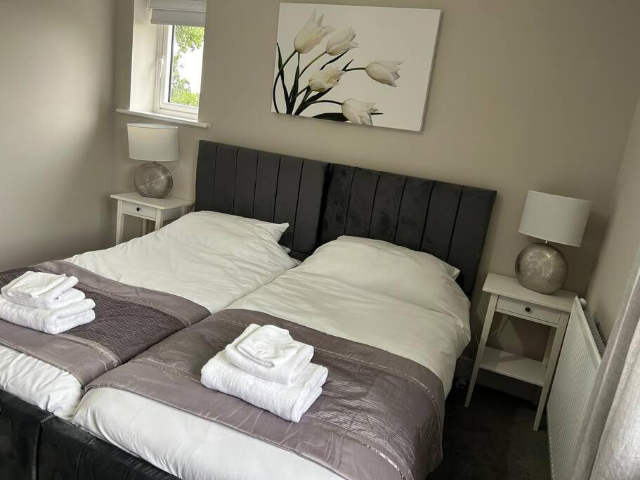 a bedroom with a bed with towels on it at Meadow View in Alfreton