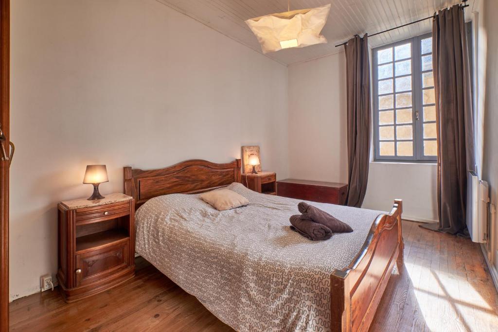 a bedroom with a large bed and a window at Location Au Pied Du Vercors in Vinay