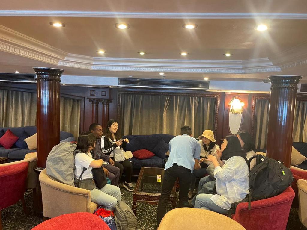 a group of people sitting in a living room at Jamaica Guest House in Aswan