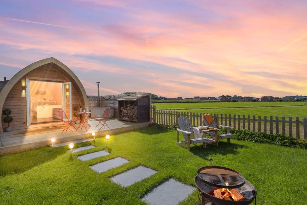 a backyard with a gazebo and a fire pit at Chapterhouse, Cathedral View, Wells in Wells