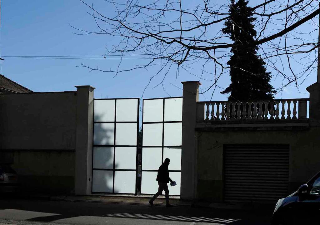 a person walking past a building with large windows at Hotel de la muraille de sens in Sens