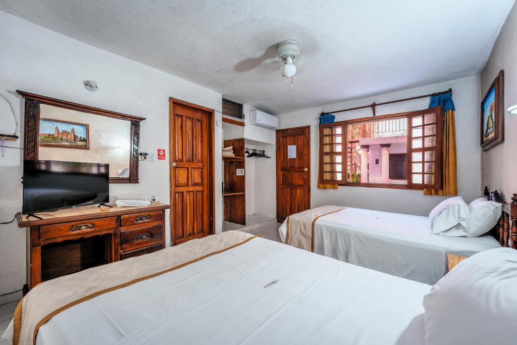 Postel nebo postele na pokoji v ubytování Hotel Santa Lucía