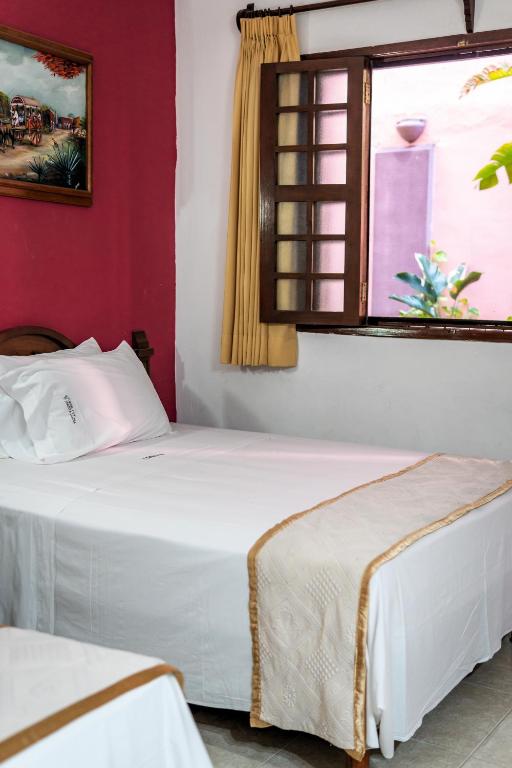 Postel nebo postele na pokoji v ubytování Hotel Santa Lucía