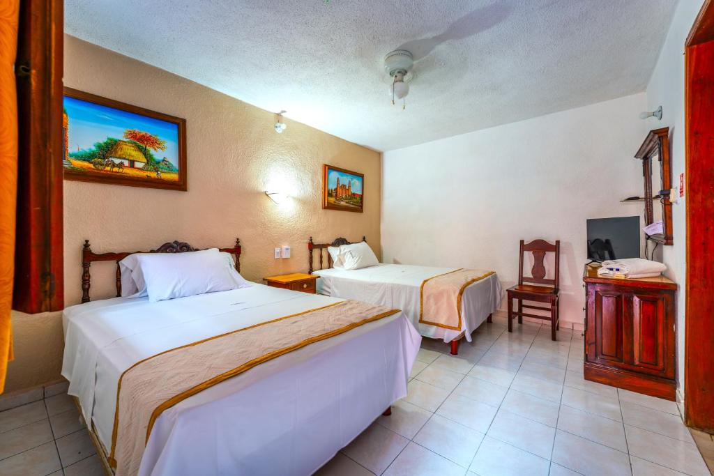 Postel nebo postele na pokoji v ubytování Hotel Santa Lucía