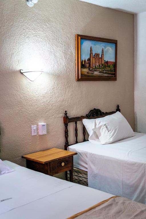 Postel nebo postele na pokoji v ubytování Hotel Santa Lucía