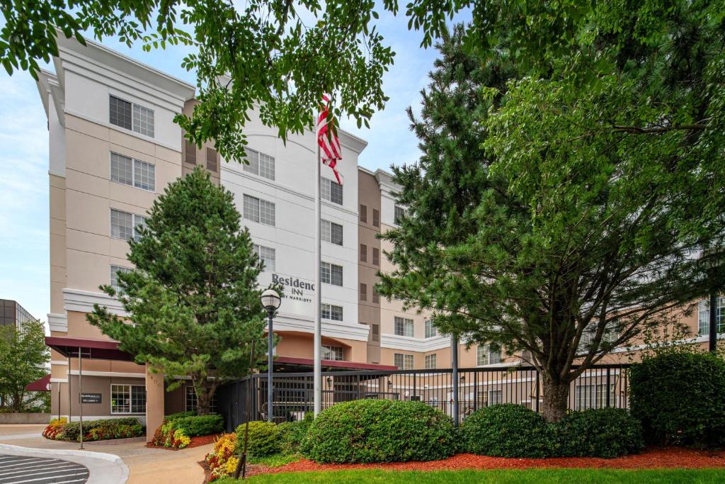 an image of the front of a hotel with trees at Residence Inn by Marriott Tysons in Tysons Corner