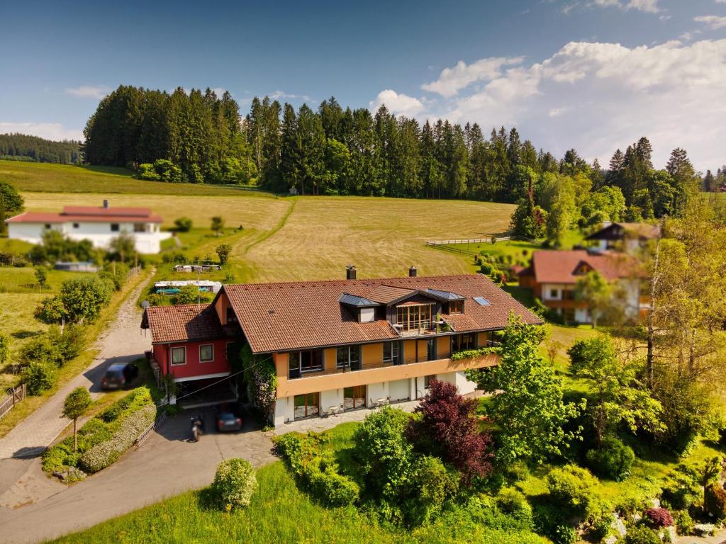 an aerial view of a house in a field at Freiraum in Weiler-Simmerberg