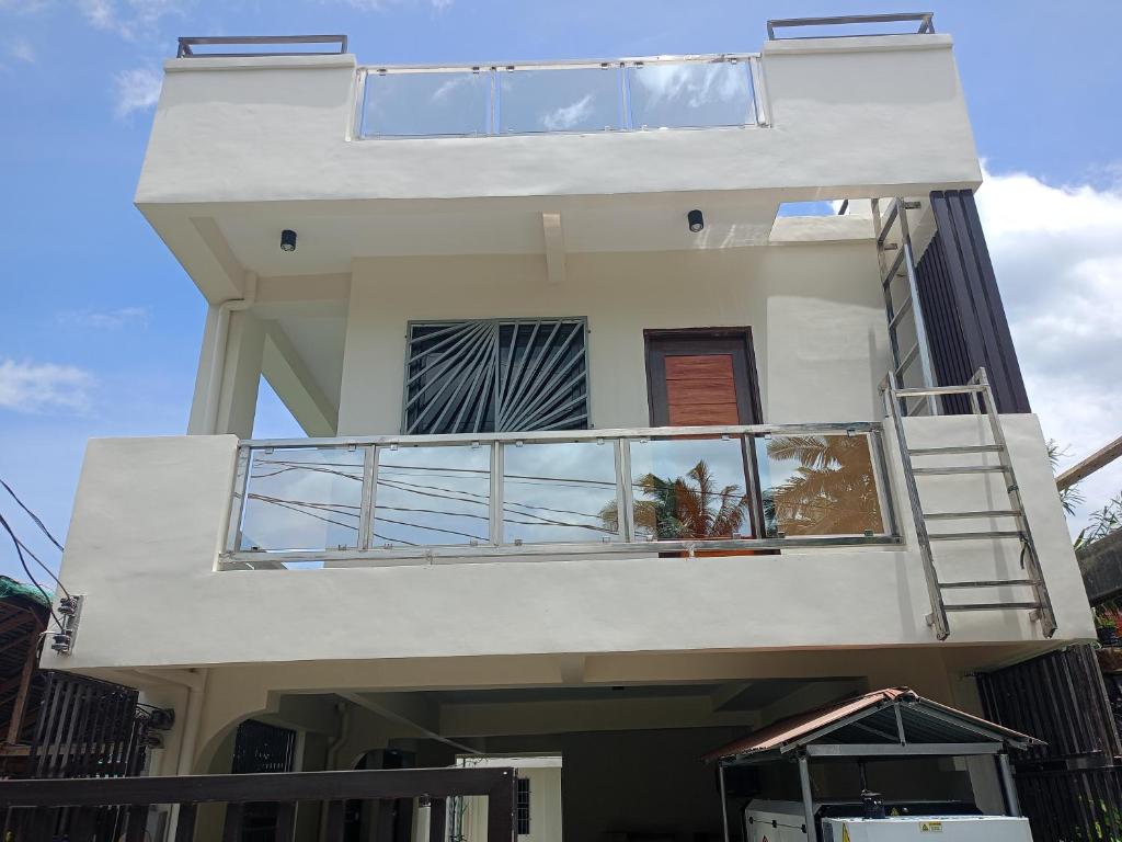 a house with a balcony on the side of it at J&S lodging house in Baler