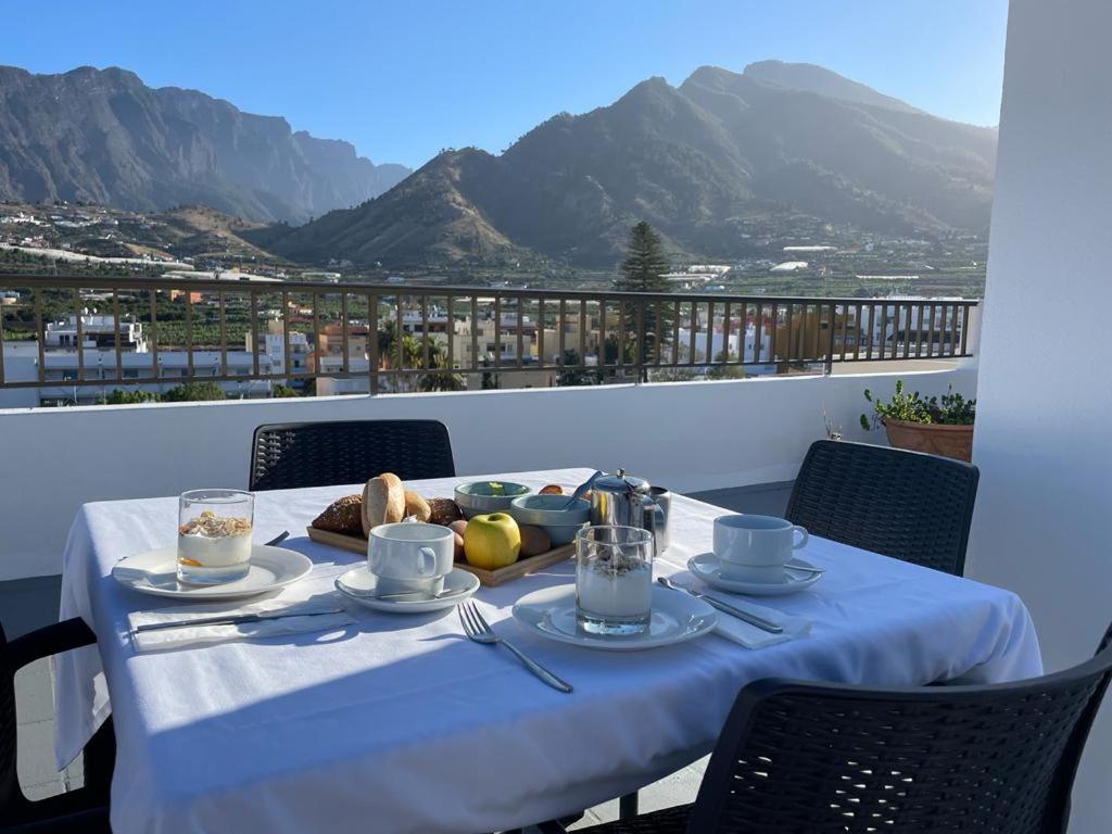une table avec une assiette de nourriture sur un balcon dans l'établissement Hotel Valle Aridane, à Los Llanos de Aridane