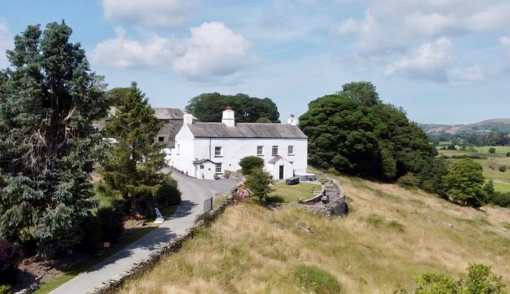an aerial view of a white house on a hill at Greenbank Farm House in Cartmel