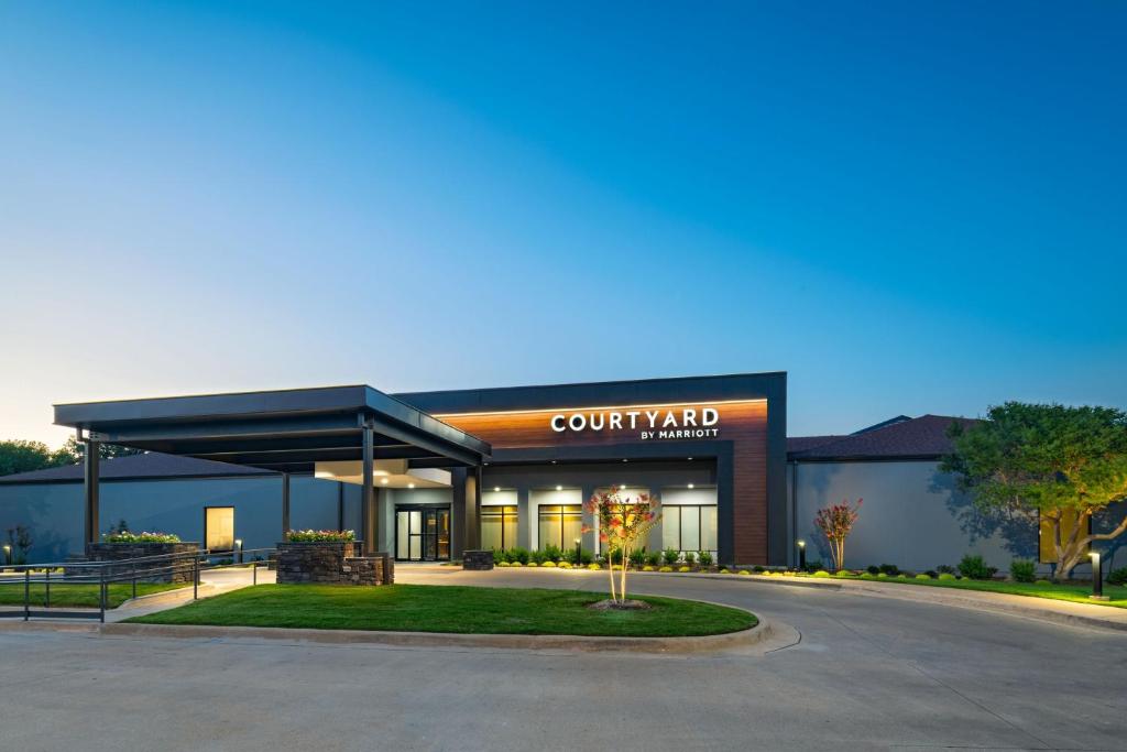 a building with a court yard sign in front of it at Courtyard Fort Worth University Drive in Fort Worth