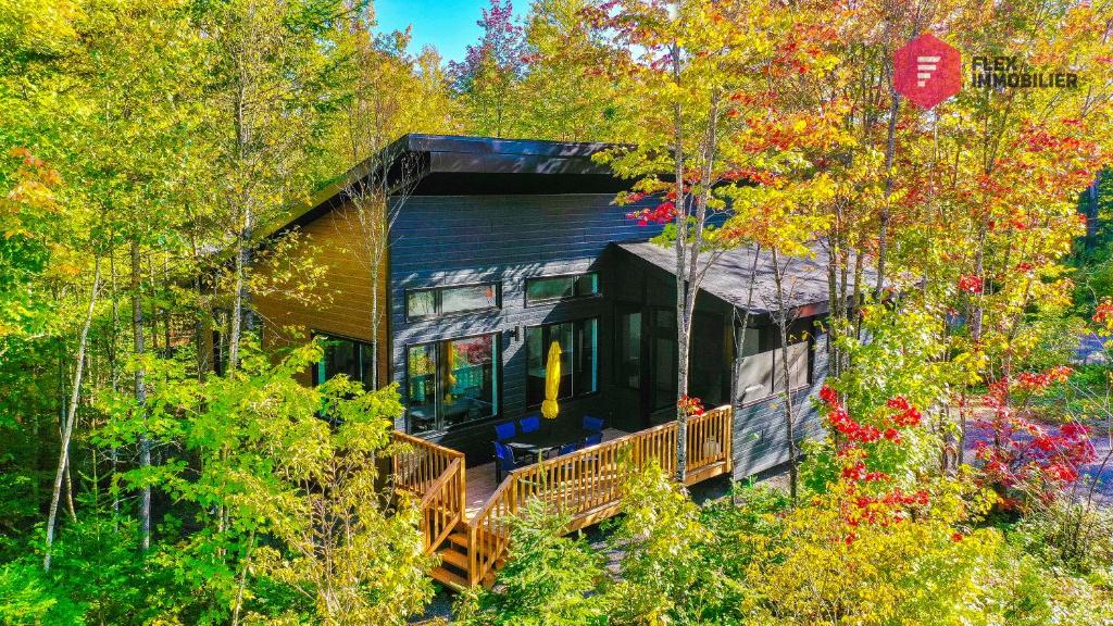 a house in the woods with trees at La Sunny-Haus de Portneuf / 25 min from Quebec City in Pont-Rouge