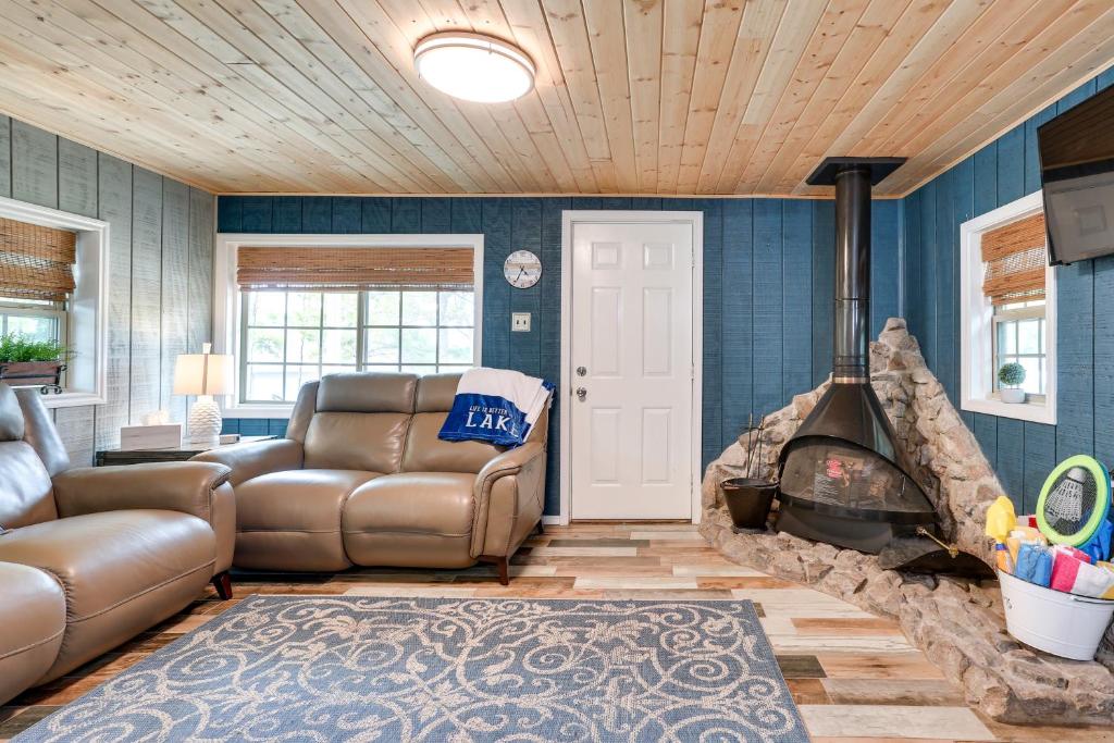 a living room with a couch and a fireplace at Kingston Cabin Rental Walk to Lake Texoma Beaches in Shay