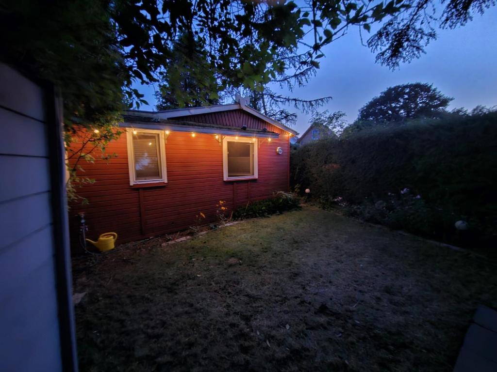 a small house with lights on the side of it at Bungalow 54 N 11,45 E in Insel Poel