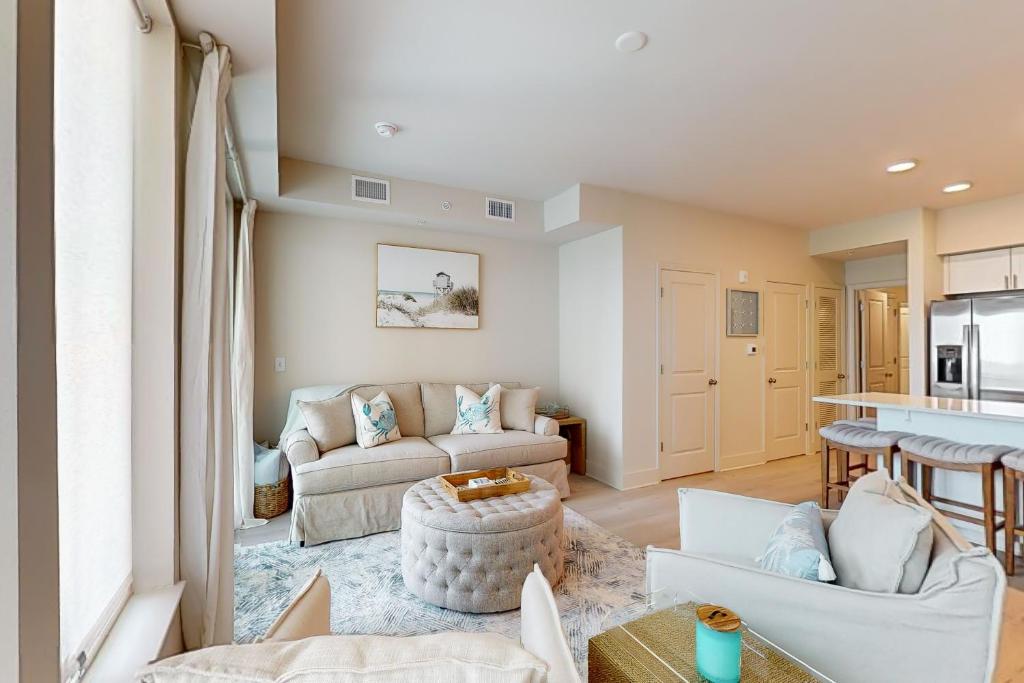 a living room with a couch and a table at Sea Glass 208 in Gulf Shores