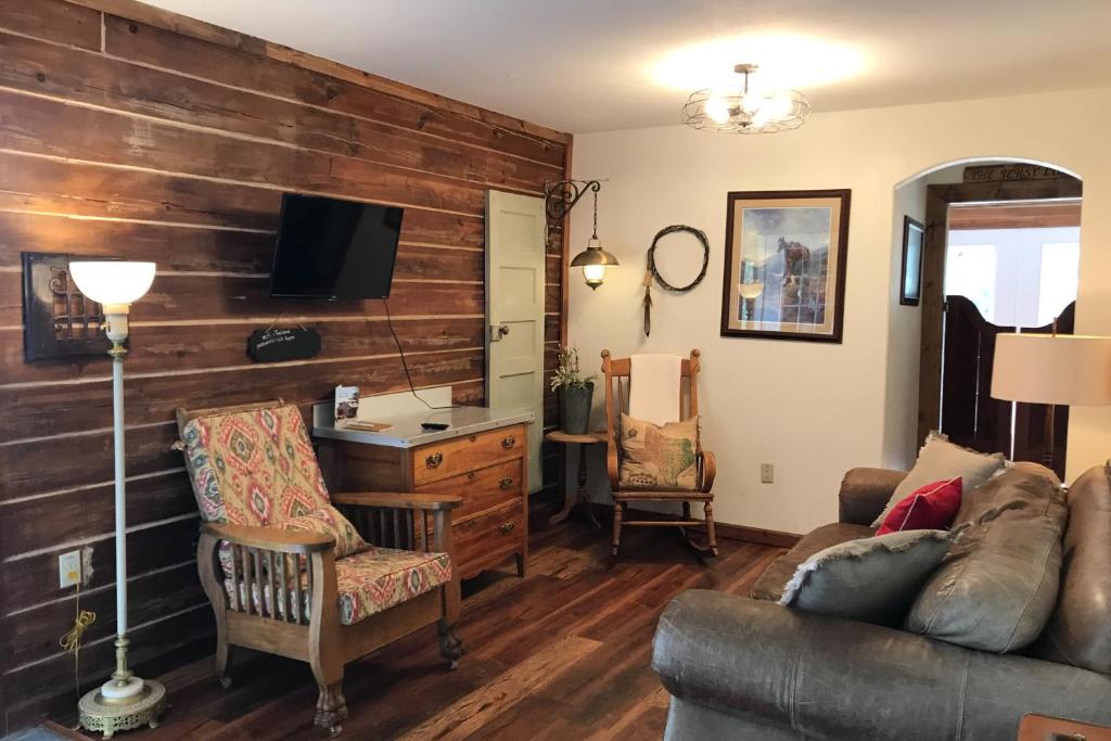 a living room with a couch and a desk at Trail's End in South Fork