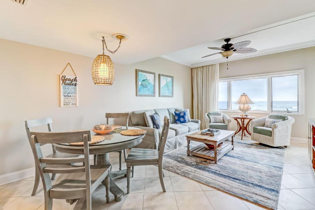 a living room with a table and a couch at 291 Sandcastles in Amelia Island