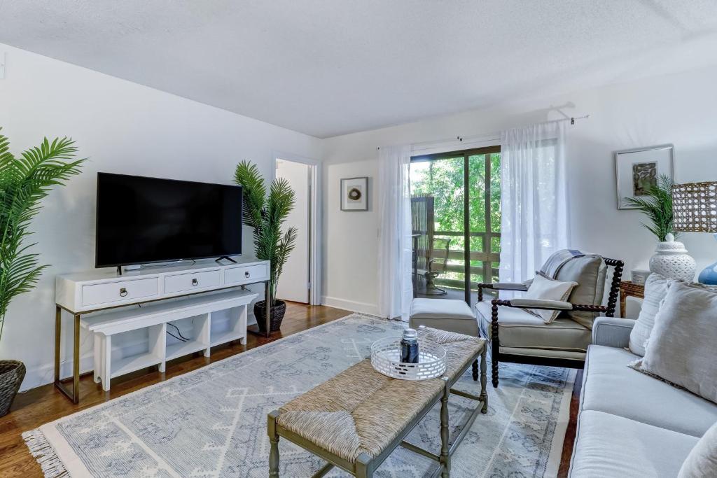 a living room with a tv and a couch at Amelia Landings 6C in Amelia Island