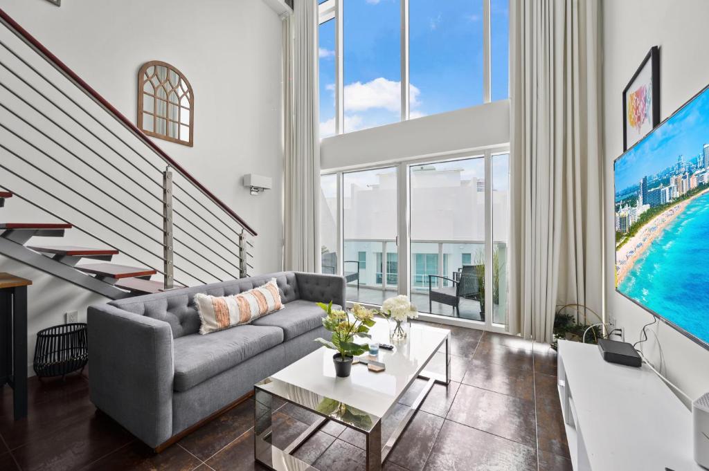 a living room with a couch and a table at Amazing Loft Style 1 Bedroom In Brickell Miami in Miami