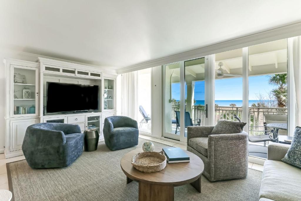 a living room with a couch and chairs and a television at 1380 Shipwatch in Amelia Island