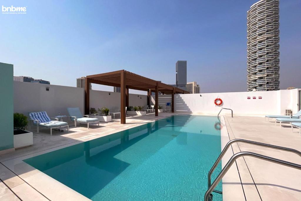 a swimming pool on the roof of a building at bnbmehomes - Modern Luxury Studio in heart of JVC - 419 in Dubai