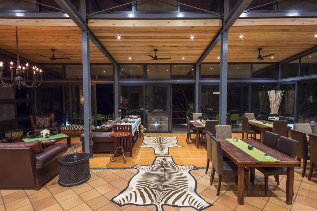 a restaurant with a zebra rug on the floor at Greenfire Game Lodge in Balule Game Reserve
