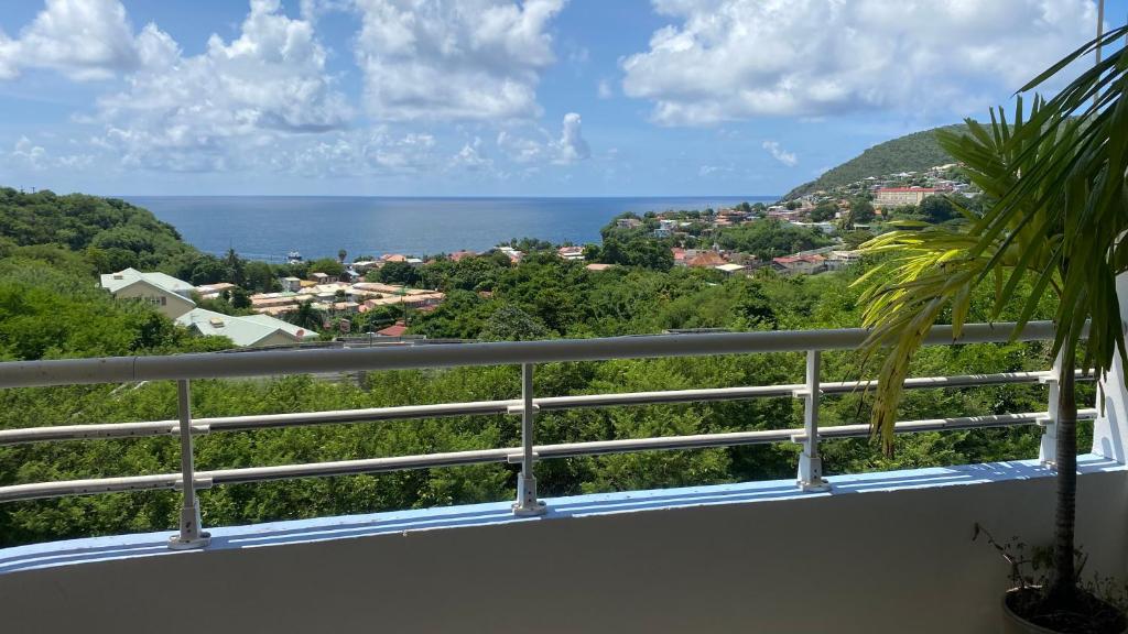 a view of the ocean from the balcony of a house at Appartement F3 Vue Mer in Case-Pilote