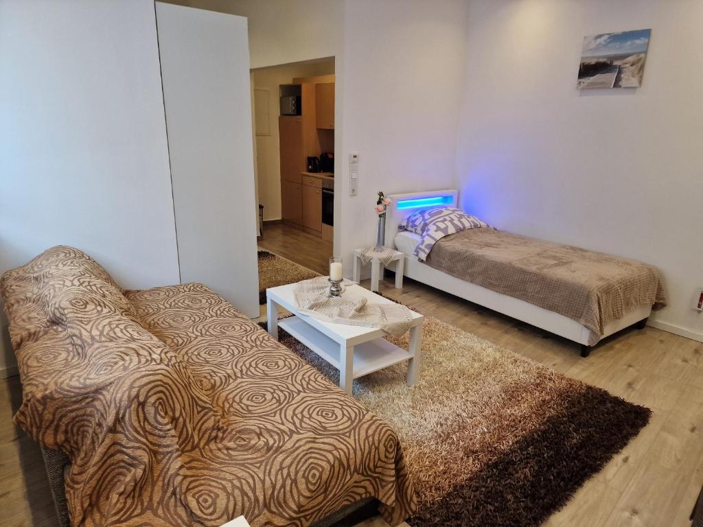 a living room with a couch and a bed at Apartment Wuppertal Heckinghausen in Wuppertal