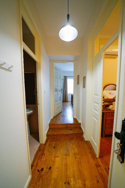 a hallway leading to a room with a hard wood floor at Alijo Vintage House in Alijó