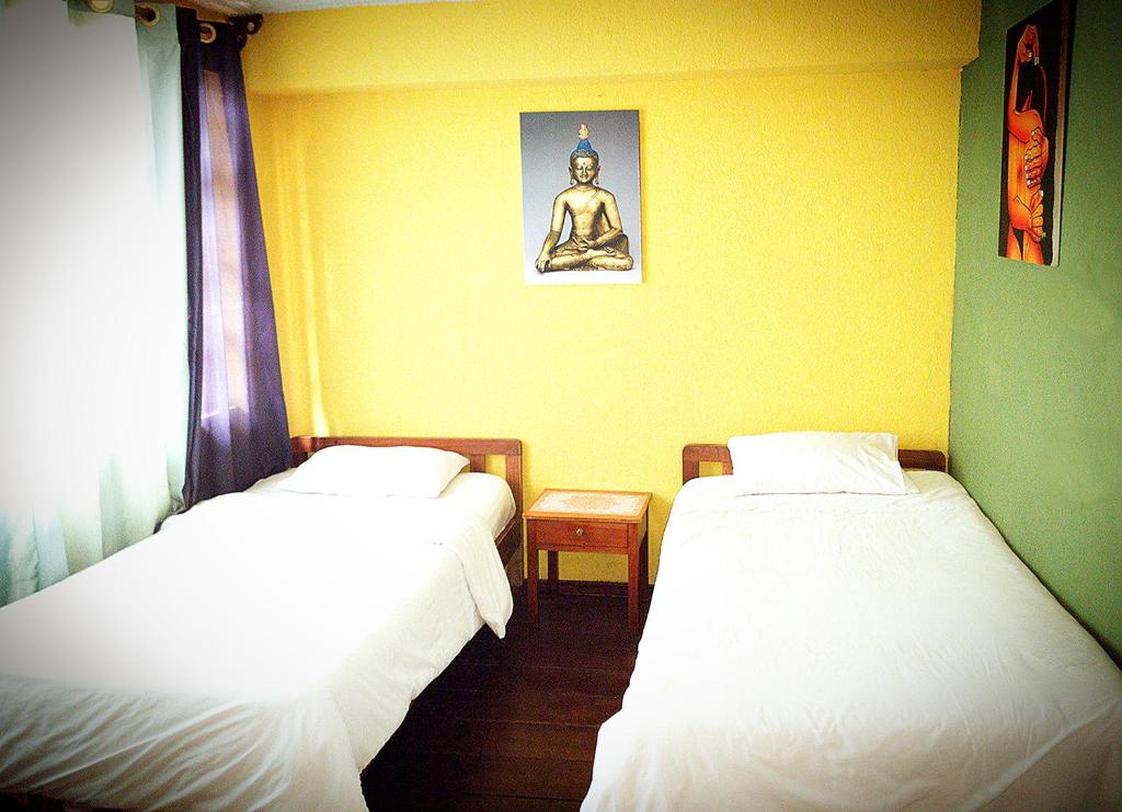 Cama o camas de una habitación en Hostal Inti raymi Backpackers