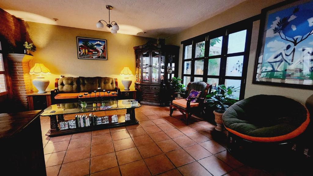 un soggiorno con divano e sedia di MAGNOLIAS a Antigua Guatemala