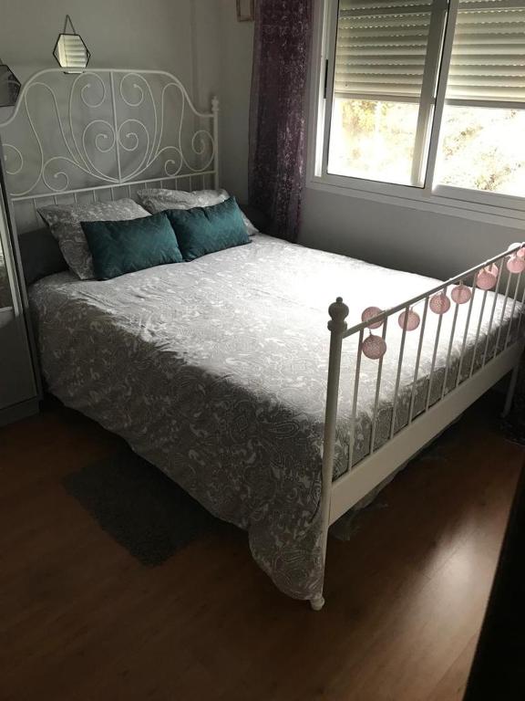a bedroom with a white bed and a window at Casa Lucía in Breña Baja