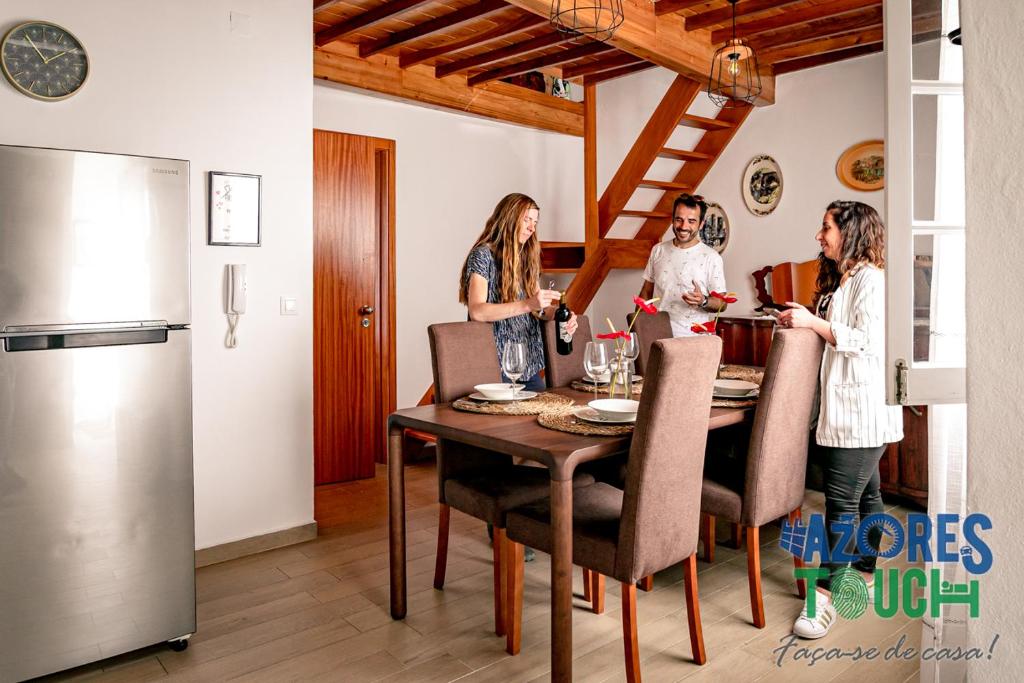 a group of women standing around a table in a kitchen at Atlântida Dream T2 in Angra do Heroísmo