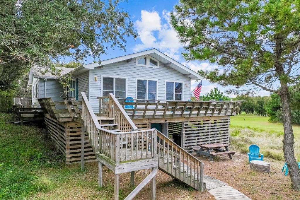 a house with a deck and stairs leading up to it at 4720 Summer Ln in Kitty Hawk