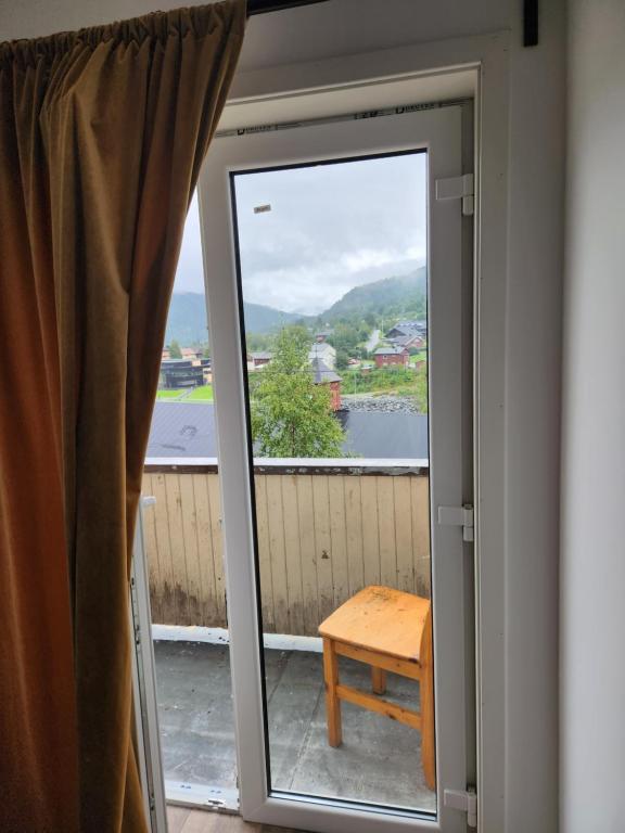 eine Tür, die auf einen Balkon mit einem Fenster führt in der Unterkunft emmas in Bratterud